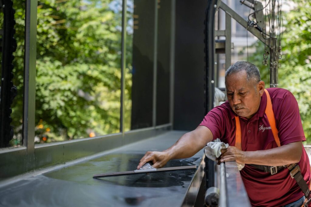 Man in Signature shirt working on stone restoration