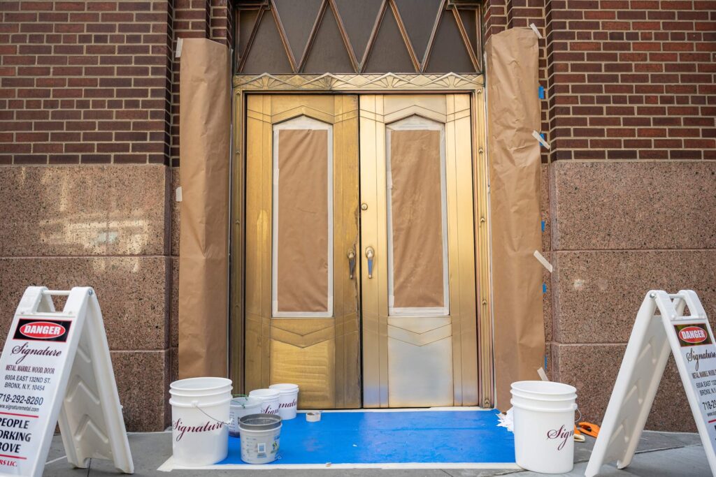 Historic building with metal doors and stone, restoration and maintenance services by Signature Metal, New York