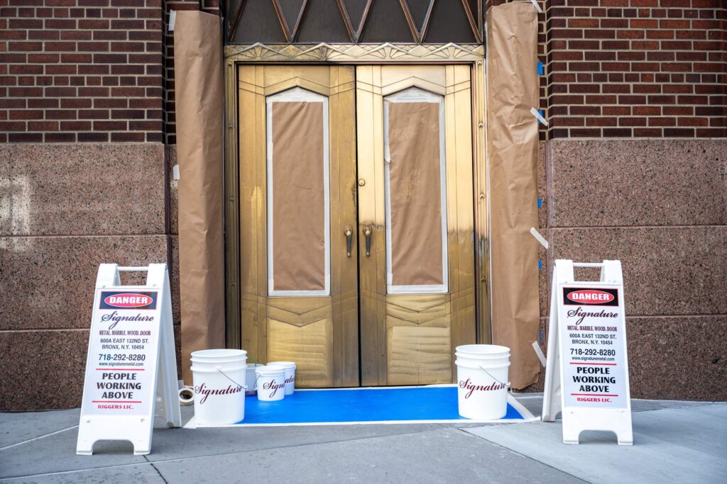 Historic building with metal doors and stone, restoration and maintenance services by Signature Metal, New York